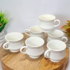 White Ceramic Or Bone China Tea Cup With Gold Silver Trim Lines Around The Rim And Base. Set Of 6