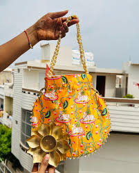 Budget Friendly Metal Diya With Pichwai Potli Bags